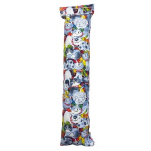 May include: A long, cylindrical catnip toy with a blue fabric exterior. The fabric is covered in a colorful pattern of cartoon cats with different expressions and colors. The toy is sewn shut at both ends.