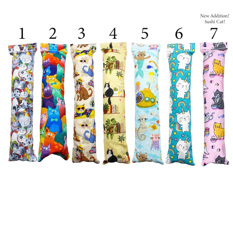 May include: Seven colorful cat-themed catnip toys, each with a different design. The toys are arranged in a row from left to right, numbered 1 through 7. The toys are all about 10 inches long and are made of soft fabric.