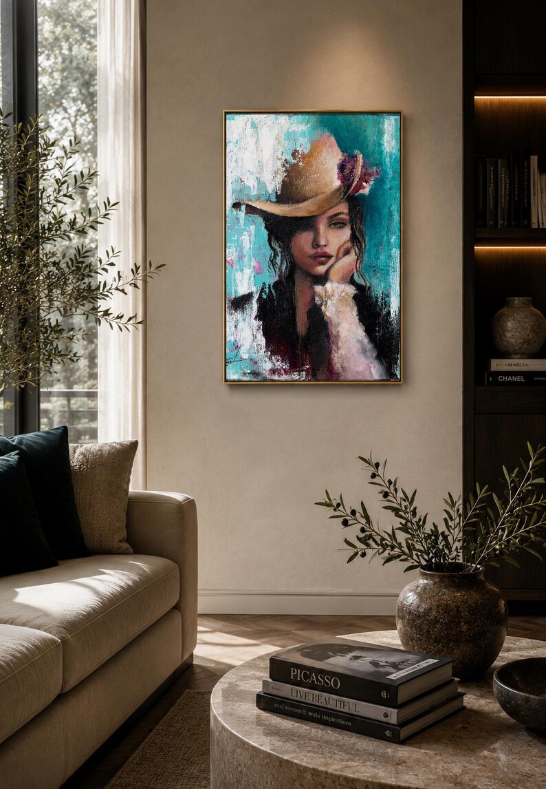 May include: A rectangular framed wall art piece featuring an oil painting of a person wearing a tan hat with a floral accent. The portrait is set against a textured background of vibrant turquoise, white, and black paint strokes with visible brushwork.