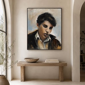 May include: A square framed oil painting depicting a portrait of a person with dark hair, wearing a white collared shirt under a dark jacket. The subject has a downward gaze, rendered in muted tones of brown, black, white, and soft blue.