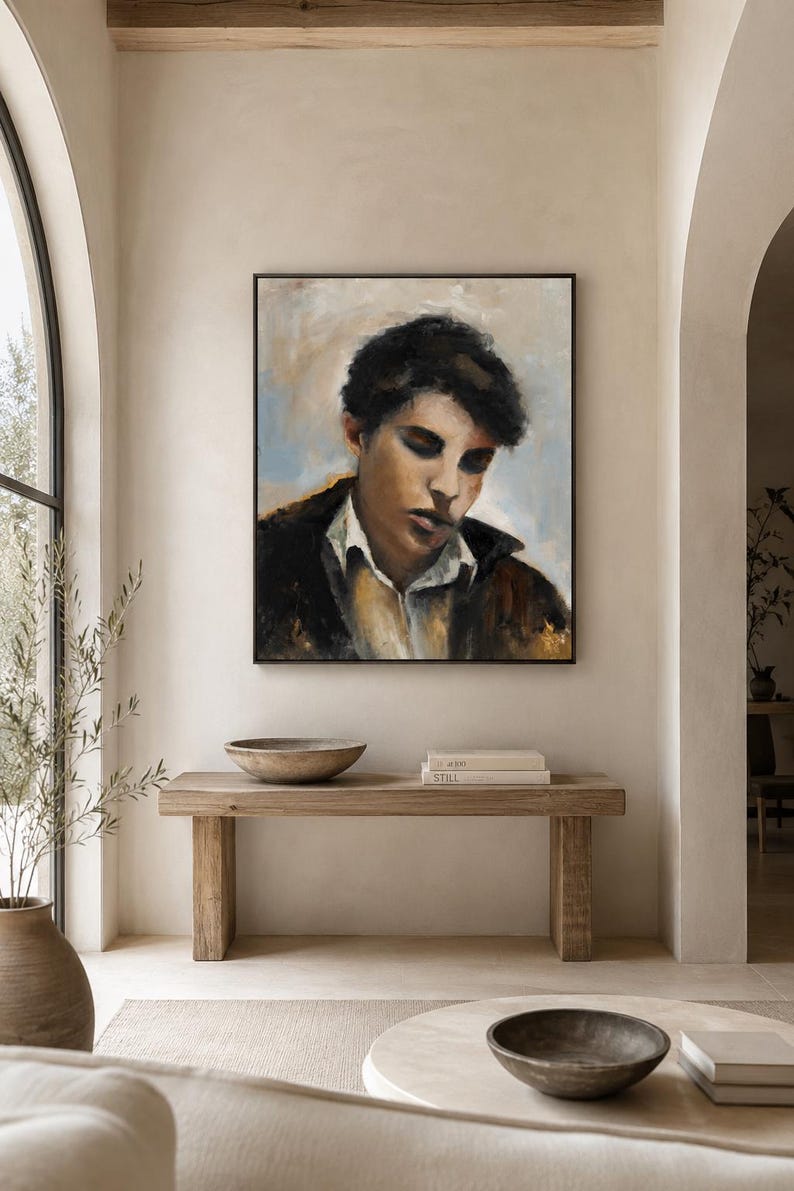 May include: A square framed oil painting depicting a portrait of a person with dark hair, wearing a white collared shirt under a dark jacket. The subject has a downward gaze, rendered in muted tones of brown, black, white, and soft blue.
