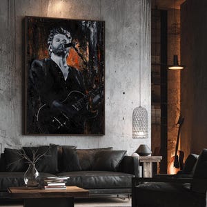 May include: A rectangular wall art print featuring a black and white portrait of a musician singing into a microphone while playing an electric guitar. The artwork has a dark, textured background with splashes of orange and black paint strokes.