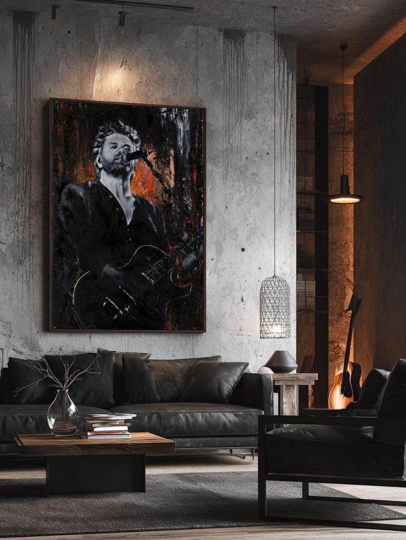 May include: A rectangular wall art print featuring a black and white portrait of a musician singing into a microphone while playing an electric guitar. The artwork has a dark, textured background with splashes of orange and black paint strokes.