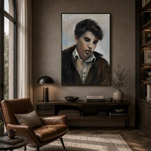 May include: A framed oil painting depicting a portrait of a person with dark hair, wearing a white collared shirt under a dark brown jacket, set against a muted background with soft blue and beige tones, displayed in a vertical rectangular frame.