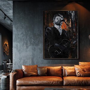May include: A rectangular wall art print featuring a black and white portrait of a musician singing into a microphone while playing an electric guitar, accented with textured dark tones and subtle hints of orange and red throughout the composition.