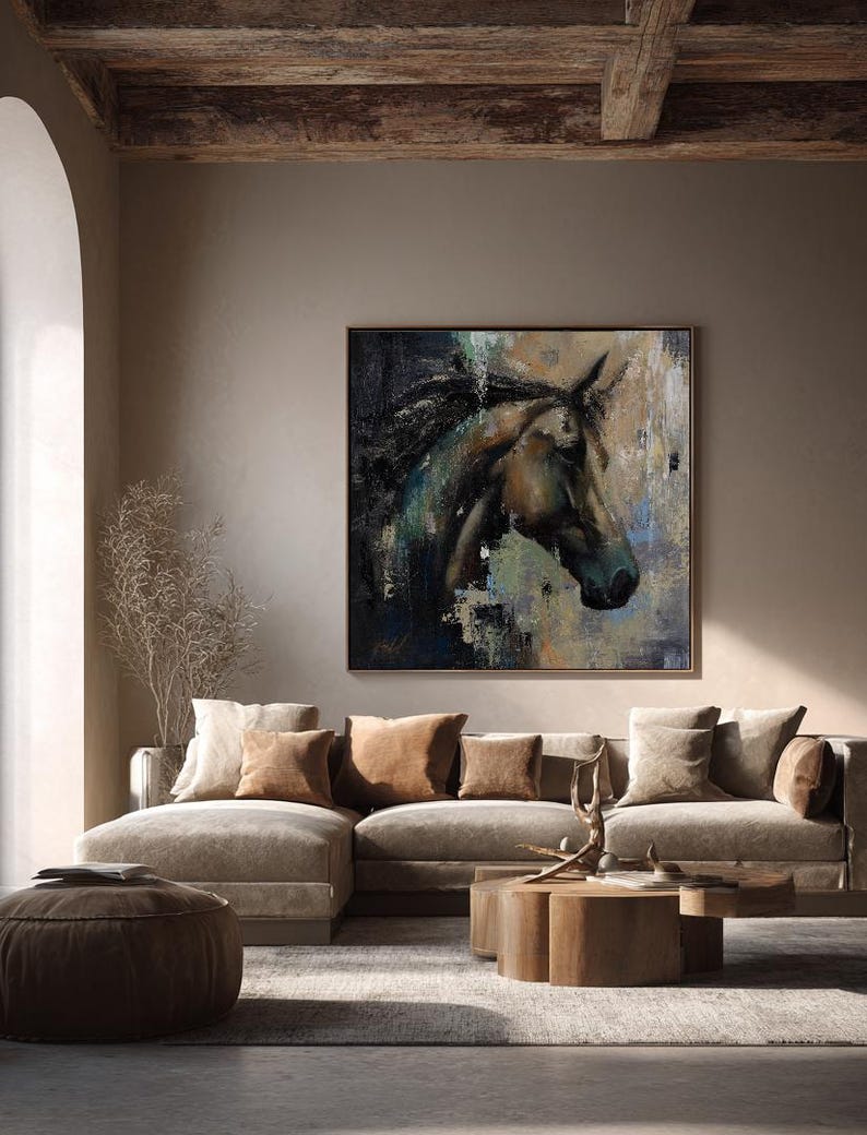 Puede incluir: Una pieza de arte mural cuadrada que presenta una pintura abstracta de una cabeza de caballo de perfil. La obra utiliza una paleta de tonos marr&oacute;n oscuro, negro, azul apagado y beige con pinceladas visibles y capas texturizadas, enmarcada en un borde de madera fino.
