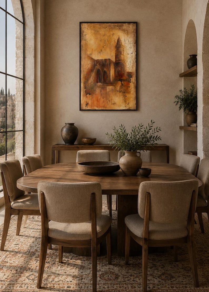 May include: A rectangular framed painting featuring an abstract architectural scene in warm shades of ochre, brown, and orange. The artwork displays a tall tower and arched structures with a textured, weathered finish, mounted on a neutral wall.