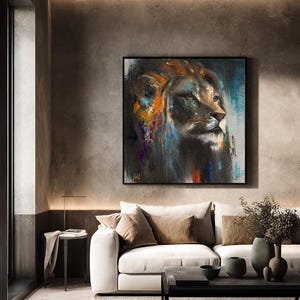 May include: A square wall art piece featuring an abstract oil painting of a lion's head in profile. The artwork uses a dark color palette with vibrant streaks of orange, blue, and purple paint, set within a thin black frame on a textured wall.