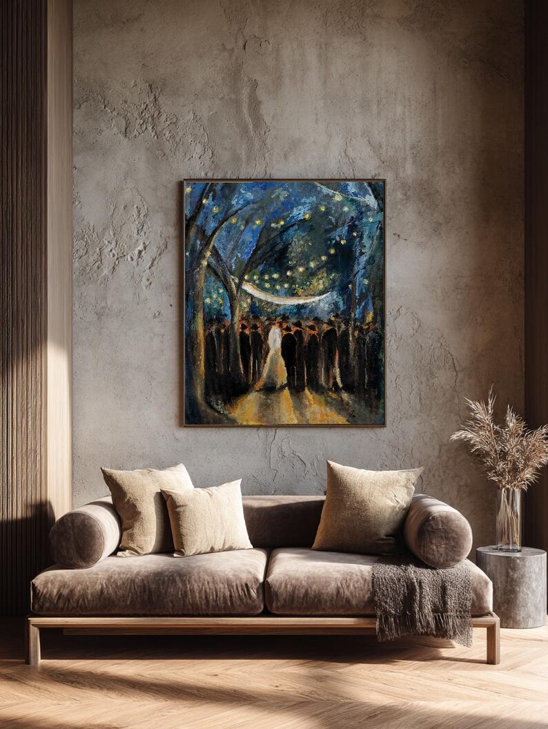 May include: An abstract painting in a gold frame depicts a wedding scene under a canopy of blue trees with string lights. The painting hangs above a brown velvet sofa with beige cushions.
