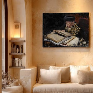 May include: A rectangular wall art print depicting an elderly person with a beard and dark hat reading a large open book. The artwork features dark tones and gold embroidery details on the clothing, displayed in a room with beige walls.