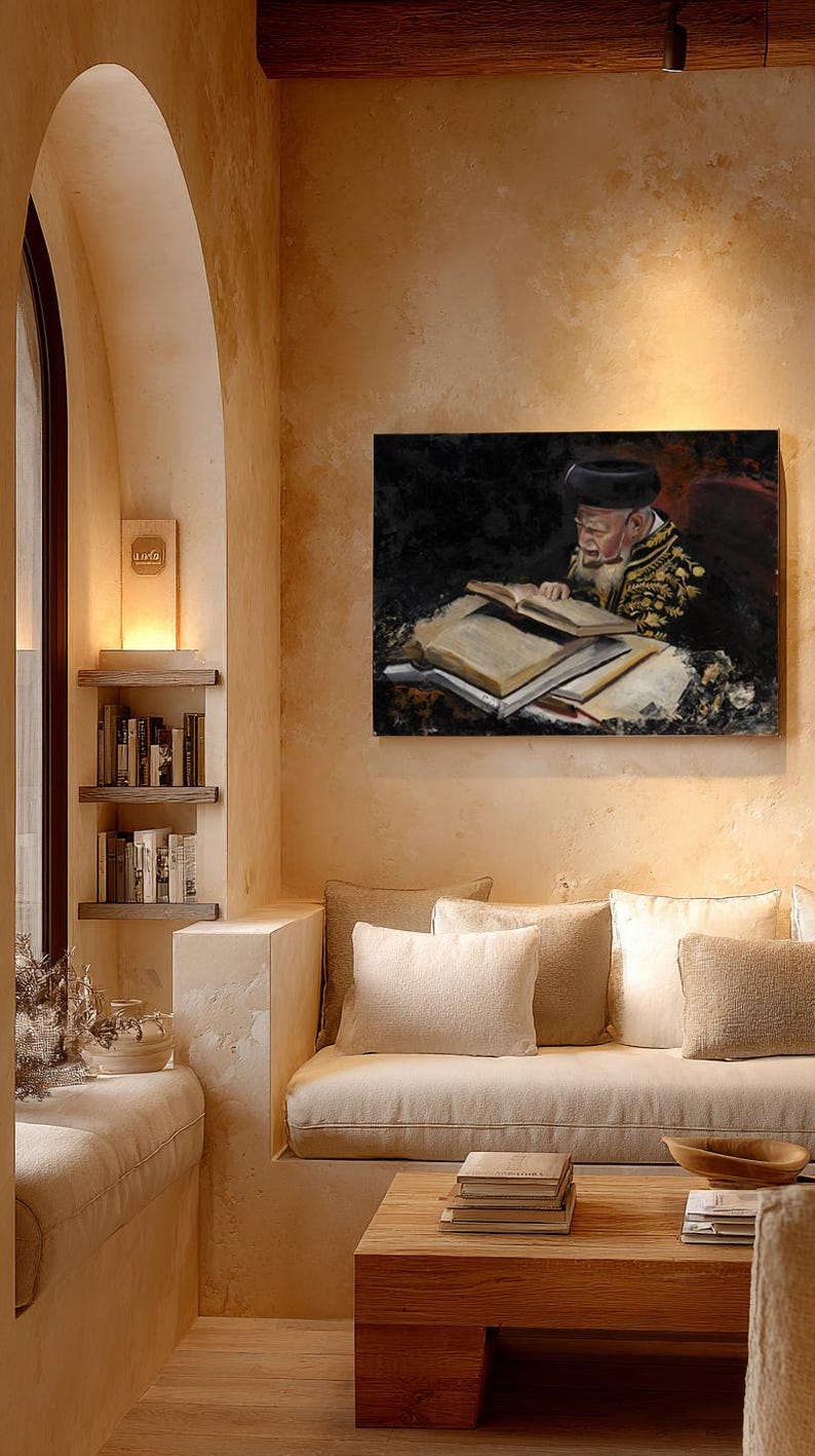May include: A rectangular wall art print depicting an elderly person with a beard and dark hat reading a large open book. The artwork features dark tones and gold embroidery details on the clothing, displayed in a room with beige walls.