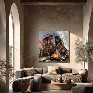 May include: A square wall art print featuring an oil painting of a family sitting around a campfire. The scene depicts a person with a feathered headdress, another person, and a small child, all rendered with textured brushstrokes and warm tones.