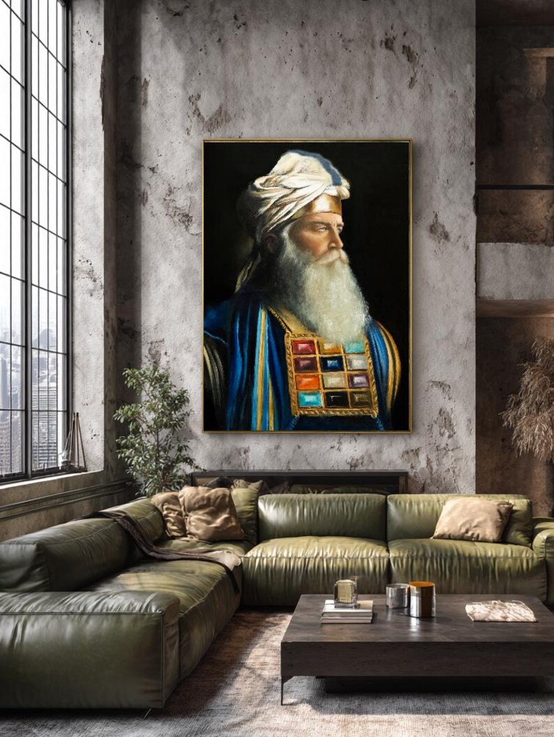 May include: A framed portrait painting of a bearded individual wearing a white turban and a blue robe with a gold-trimmed chest piece featuring twelve colourful square gemstones arranged in a grid against a solid black background.