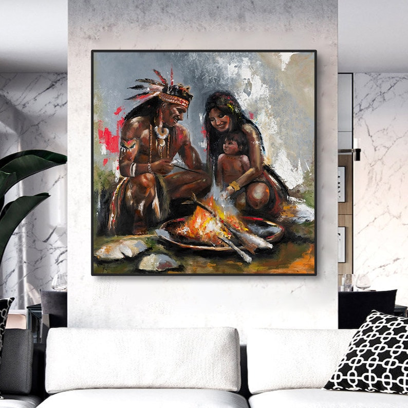 May include: A square oil painting depicting a family sitting around a campfire. The scene features a person with a feathered headdress, another person, and a small child. The color palette includes warm orange and yellow flames against a gray background.