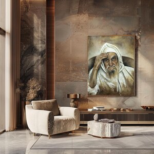 May include: A rectangular framed oil painting depicting an elderly person with a long beard wearing a white hooded garment, with one hand resting on their forehead. The artwork features muted brown and white tones with visible brushstrokes.
