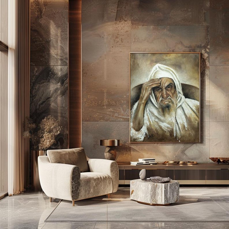 May include: A rectangular framed oil painting depicting an elderly person with a long beard wearing a white hooded garment, with one hand resting on their forehead. The artwork features muted brown and white tones with visible brushstrokes.