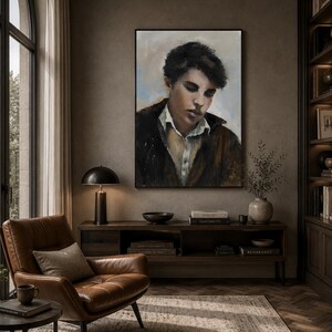 May include: A framed oil painting depicting a portrait of a person with dark hair, wearing a white collared shirt under a dark brown jacket, set against a muted background with soft blue and beige tones, displayed in a vertical rectangular frame.