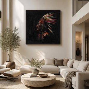 May include: A square framed oil painting depicting the profile of a person wearing a vibrant, multi-colored feathered headdress against a dark, textured black background. The artwork features bold brushstrokes in red, yellow, and blue tones.