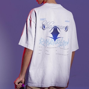 May include: A light gray t-shirt featuring the text "Hogwarts Ravenclaw" in blue script. The shirt has a crew neck and short sleeves. The design includes the Hogwarts School logo and a stylized raven graphic.