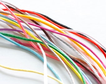 May include: A collection of colorful embroidery floss spools in various shades of red, orange, yellow, green, blue, purple, pink, brown, white, and black.