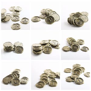 May include: A set of 10 antique gold-toned metal alphabet letter charms. Each charm features a different letter of the alphabet, from A to J. The charms are perfect for adding a vintage touch to jewelry, crafts, and other projects.