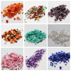 May include: A collection of colorful beads in various shapes and sizes. The beads are arranged in nine separate piles, showcasing a range of colors including orange, green, purple, and blue. Ideal for jewelry making and crafting.