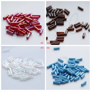 Könnte beinhalten: Vier Gruppen von Glasperlen in verschiedenen Farben. Die erste Gruppe ist rot, die zweite braun, die dritte weiß und die vierte blau.