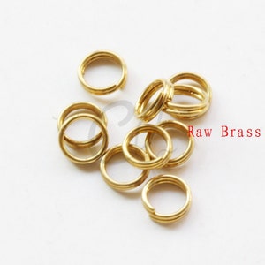 May include: A close-up of a pile of 10 gold-colored jump rings. The rings are made of raw brass and are approximately 1/2 inch in diameter.  Raw Brass.