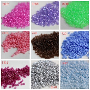 May include: A collection of small, colorful seed beads in various shades, including pink, purple, green, peach, brown, blue, burgundy, silver, and light blue. Each color is displayed in a separate square, with a number in the top left corner.