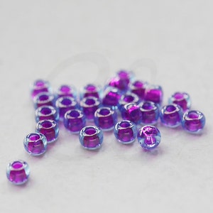 10 Gramm Japanische Miyuki 11/0 Rocailles - Aqua Fuchsia Lined Luster - 2mm (11M10-110352-N-66)