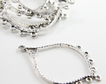 May include: Silver-toned metal earring findings with a teardrop shape and multiple small loops around the edge.