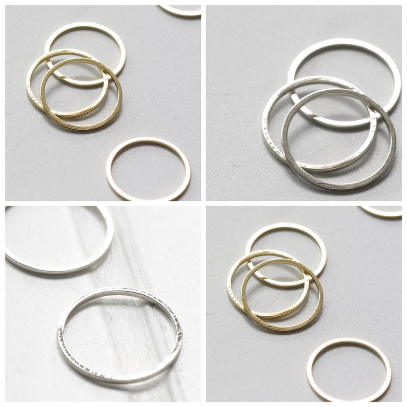 May include: Three silver rings and three gold rings, all stacked on top of each other. The rings are all different sizes and have a hammered texture.