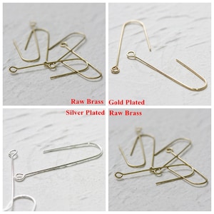 May include: Four earring hooks in different finishes: raw brass, gold plated, silver plated, and raw brass. The hooks are all the same size and shape, with a small loop at the top and a straight wire extending down to a hook at the bottom.