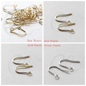 May include: Four sets of earring hooks in different finishes: raw brass, gold plated, gold plated, and silver plated. The hooks are all the same size and shape, with a small loop at the top and a curved wire that forms a hook.