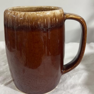 May include: A rustic wooden sign with the text "Welcome to our home" in white lettering. The sign features a distressed finish and a simple, inviting design, perfect for a front porch or entryway.