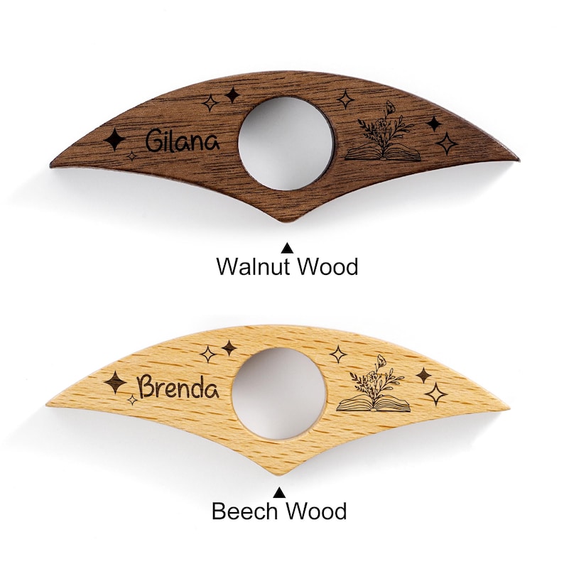 May include: Two wooden thumb page holders. One is dark brown walnut wood with the name "Gilana" and the other is light brown beech wood with the name "Brenda". Both have a circular opening and star and book designs.