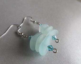 May include: Silver earrings with light blue sea glass and crystal accents.