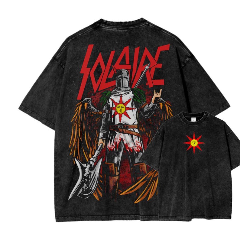 May include: Black graphic t-shirts featuring a knight with a sun emblem and the word "SOLAIRE" in red. The knight is holding an axe and has wings. A smaller shirt with a sun emblem is also visible.