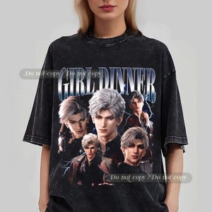May include: Black t-shirt featuring a graphic design with the text "GIRL DINNER" in a silver, stylized font. The design includes multiple images of a male character with silver hair. The shirt has a vintage, distressed look.