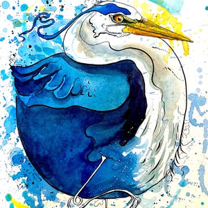 May include: Watercolor painting of a blue heron with white and blue feathers, a yellow beak, and an orange eye. The bird is set against a background of blue and yellow paint splatters. The artwork is signed in the bottom right corner.