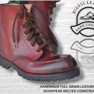 May include: A pair of deep red full-grain leather boots with brown laces and a thick black lug sole. The boots feature Goodyear welted construction. A logo reads Rigeli Leather Hand Crafted, and text states Handmade Full Grain Leather Boots.