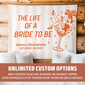 May include: A custom bachelorette party banner with the text "THE LIFE OF A BRIDE TO BE" in orange. The banner features a retro illustration of a woman in a martini glass. The banner also includes the text "Selena's Bachelorette Las Vegas, NV 20XX".