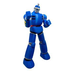 May include: A blue action figure of a robot with a white face mask and a silver helmet. The robot has a red belt and yellow accents on the arms. The figure is standing with its fists clenched.