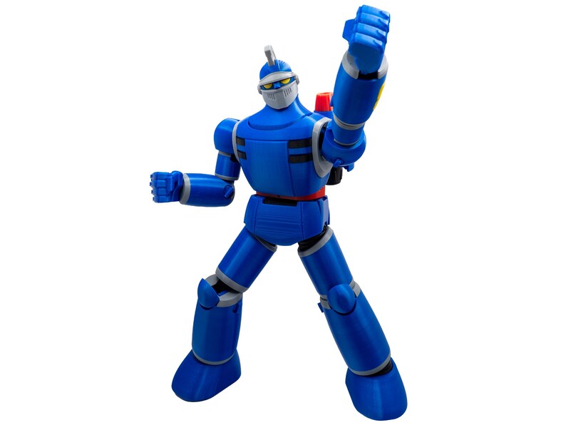 May include: A blue action figure of a robot with a helmet and a red belt. The robot has gray accents and is posed with one arm raised in a fist. The figure has a backpack and is standing on a white background.