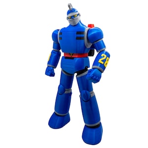 May include: A blue robot action figure with a silver helmet and face guard. The figure has a red belt, yellow accents, and the number 28 on its arm. It stands on a white background.
