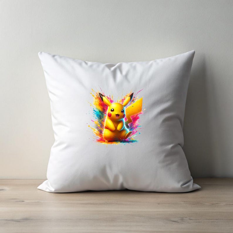 May include: White pillow with a colorful graphic of Pikachu, a yellow electric-type Pokemon, with a bright yellow background and splashes of pink, blue, green, and orange.
