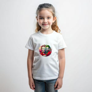 May include: White t-shirt with a colourful graphic of Harley Quinn and the Joker. The design is a vibrant splash of colours, with the characters' faces prominently displayed. The shirt is worn by a young person.