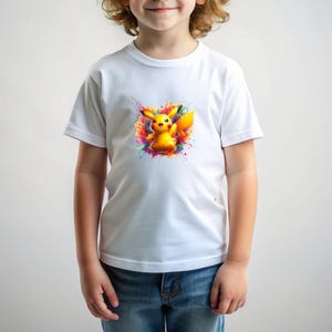 May include: A white t-shirt with a colorful graphic of Pikachu, a popular cartoon character, in a splash of paint.