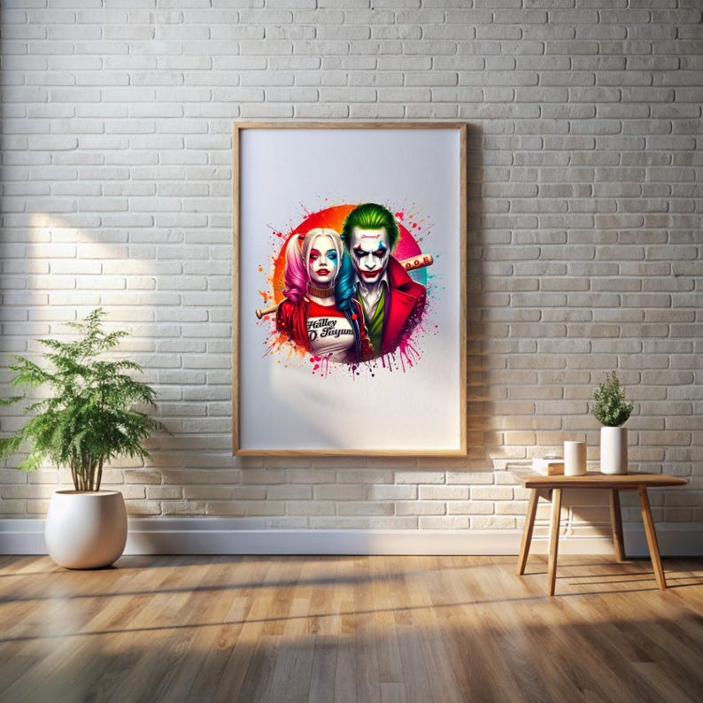 May include: A framed art print depicting Harley Quinn and the Joker in a colourful illustration. The artwork shows the characters with vibrant hair and makeup, set against a splash of paint. The print is displayed on a white brick wall.