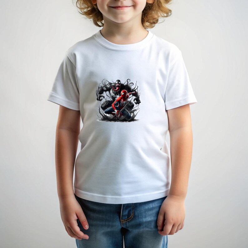 May include: A white t-shirt with a graphic print of Venom and Spider-Man fighting. The graphic is in black, red, and white.